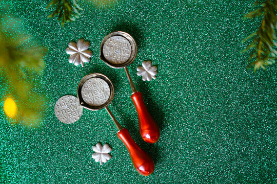 New Years Eve sparkling background. New Year predictions and traditional tin casting on Green Glitter Background for tin pouring instructions,holiday gift sets 