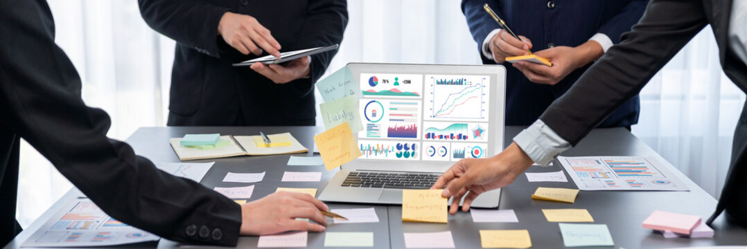 Analyst team use sticky note for creative and analytic brainstorm for business idea with BI data dashboard on laptop screen. Analysis financial data visualization tech for marketing strategy. Prodigy