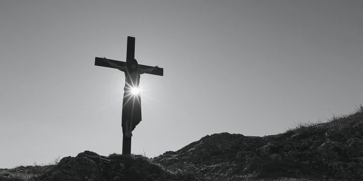 A stark, dramatic black and white image of a wooden cross silhouetted against the sun's rays, perched atop a barren hill. The sun bursts through the cross.