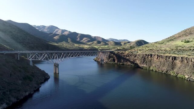 Wide shot of bridge spanning deep river canyon