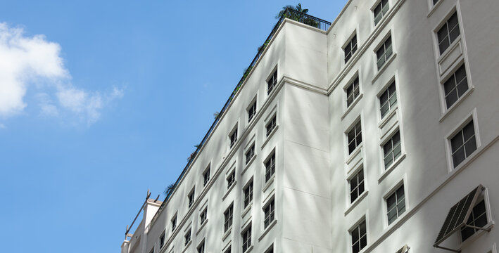 White Urban Building Facade Against Clear Blue Sky