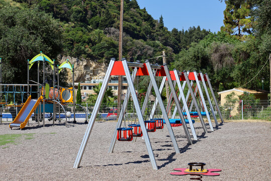 Modern Outdoor Children's Playground with Swing Set and Slide.