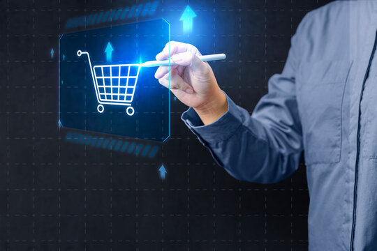 A female in a blue shirt interacts with a futuristic digital shopping cart icon with a stylus, representing digital technology. Concept of Online shopping, E-commerce and Modern Retail
