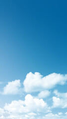 Fototapeta premium Clear bright blue sky background with fluffy white cumulus clouds at the bottom. Perfect natural background for concepts like freedom, peace, weather, and travel. Nature, natural, or quotes background