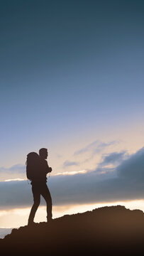 Silhouette of a male hiker with a backpack walking on a mountain ridge against a soft sunset sky, concept of travel, trekking, and outdoor adventure. Quotes background