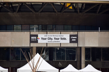 Fototapeta premium 2026 Toronto Municipal Election banner hanging on the concrete facade of City Hall
