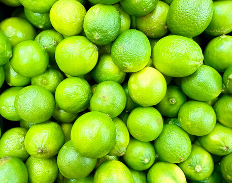 Pile of Fresh Green Limes at Mexican Market &ndash; Citrus Fruit Food Background Closeup