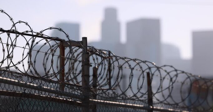 Barbed wire frames the in downtown skyline in Los Angeles, California, USA.