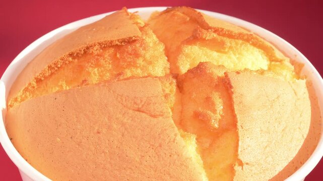 A fluffy baked sponge cake rotating close up