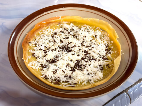 Indonesian Crispy Sweet Pancake with Grated Cheese and Chocolate Sprinkles