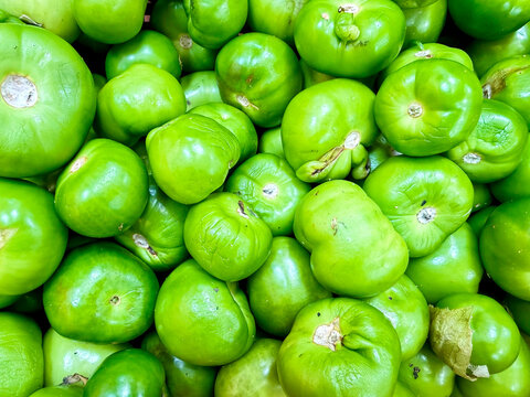 Pile of Fresh Green Tomatillos at Mexican Market &ndash; Traditional Food Ingredient Background Closeup