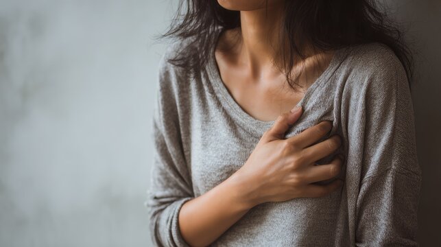 hand hold chest with heart attack symptoms, have chest pain caused by heart disease, leak, dilatation, enlarged coronary heart, press on the chest with a painful expression