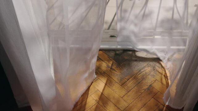 Morning Sunlight Filtering Through Sheer Curtains onto a Parquet Floor