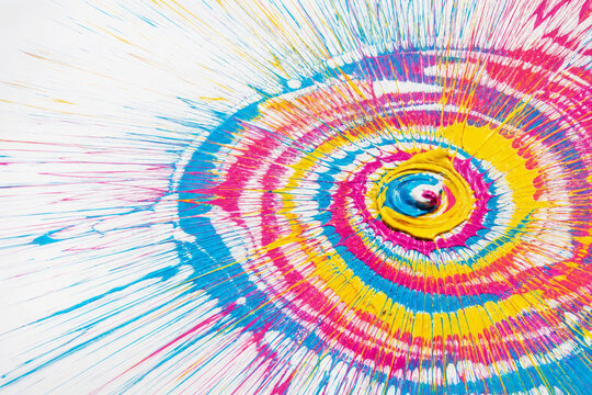 Turquoise, fuchsia, yellow and white paint radiates from a central spiral in irregular concentric rings. Centrifugal creativity and movement