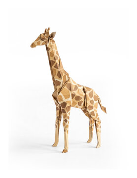 A folded origami giraffe stands on a white surface. The giraffe is constructed from brown paper with a distinctive geometric pattern resembling its natural markings.