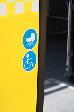 Signs indicating accessibility and stroller use near a transit station