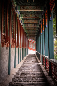 Painted red and green covered corridor with carved wooden beams, Beijing, China
