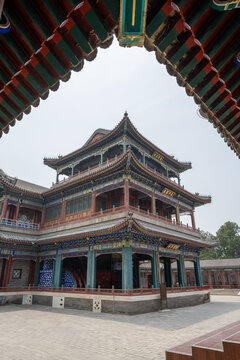 Ornate multi-tiered palace hall with upturned eaves and painted beams seen from below, Summer Palace, Beijing, China