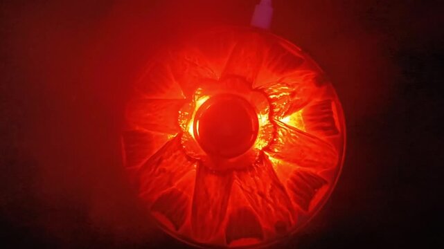 Overhead view of volcano diffuser glowing red with USB cable and rising mist