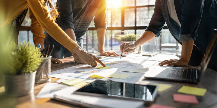 Creative Business Team Planning Strategy and Analyzing Project Documents Close Up