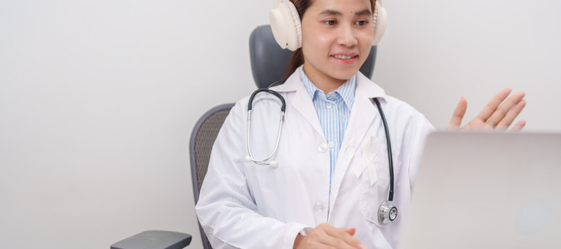 Professional doctor using laptop for telehealth, telemedical, online consultation and video meeting about November Lung Cancer Awareness month, World Cancer Day and health concept in hospital