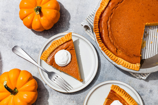 Homemade Sweet Thanksgiving Pumpkin Pie with Whipped Cream to Eat