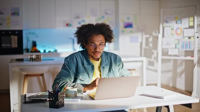 Freelancer working laptop home office. African american man drinking coffee mug