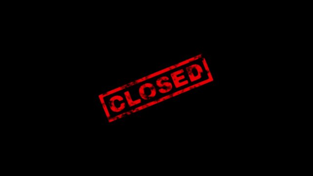 Red rubber stamp with the word closed on a black background, grunge texture effect, sign indicating business or service is currently unavailable
