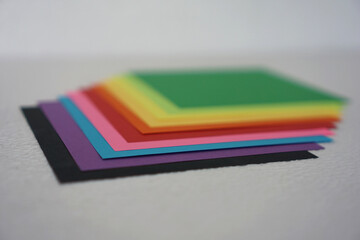 Fototapeta premium Colorful paper also known as colorful origami paper, is neatly arranged against a white background.