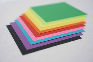 Fototapeta premium Colorful paper also known as colorful origami paper, is neatly arranged against a white background.