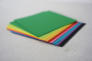 Fototapeta premium Colorful paper also known as colorful origami paper, is neatly arranged against a white background.