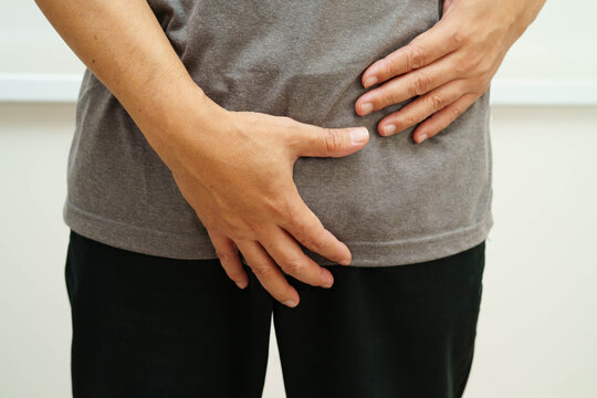 Hernia, Asian man stomach ache, abdominal pain and urology problem health.