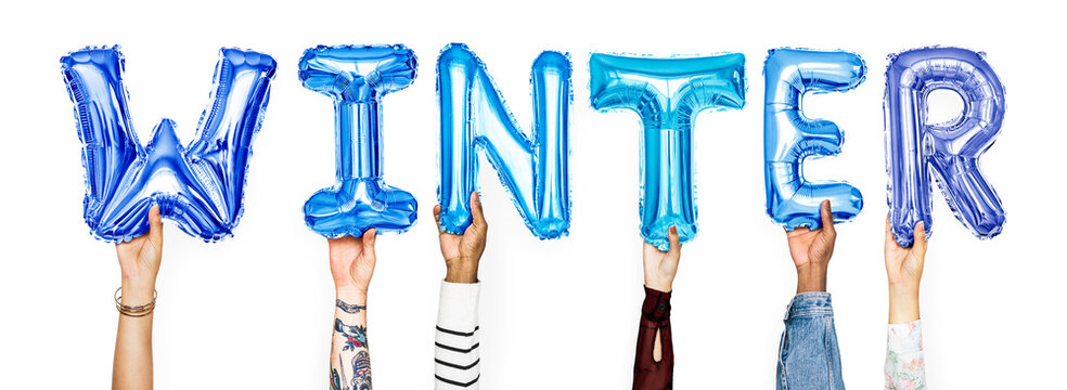 Hands holding balloons spelling Winter