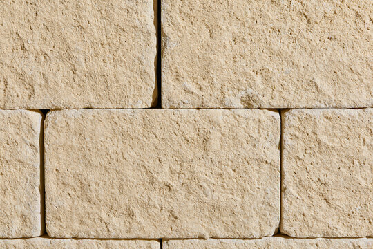 Close up view of beige stone wall block texture