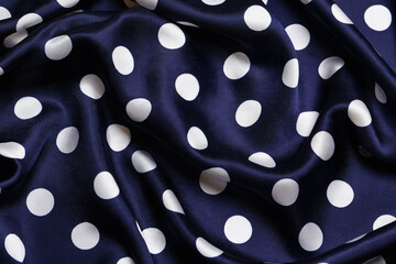 Dark blue satin fabric with white polka dot pattern © Traan