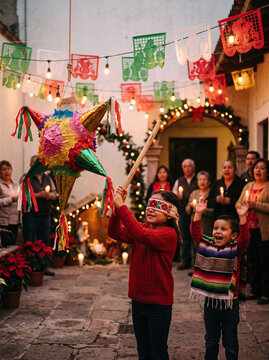 Blindfolded girl hitting a star pi&ntilde;ata during a Mexican Posadas celebration