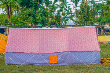 Scout tent on a green field for student school camping activity. © Musrifin
