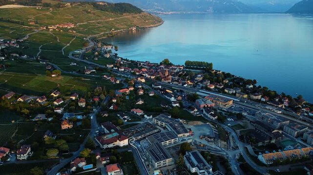 Drone advances toward Cully village, Switzerland, tilting up to reveal Alps