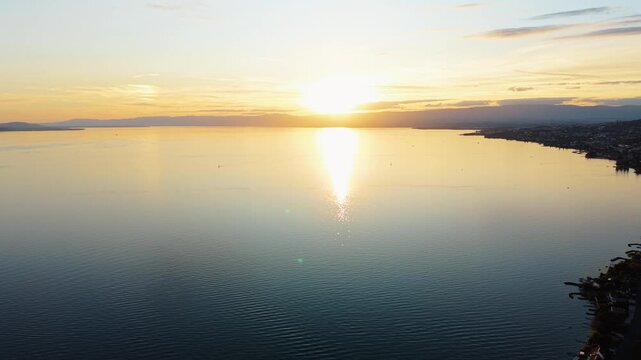 Drone advances toward the setting sun over Lake Geneva, near Cully, Switzerland