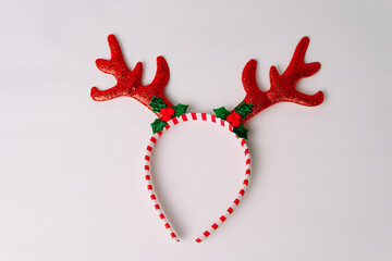 Red glitter reindeer antler headband isolated on white background, perfect for christmas party, holiday costume accessory, and winter celebration.  © Ryan