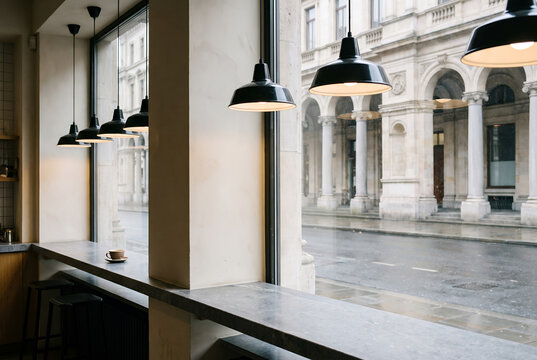 Contemporary caf&eacute; interior with pendant lights and courtyard view