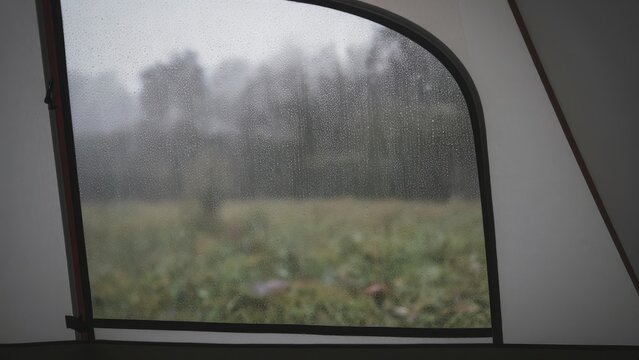Serenity Outside Tent with Rain on Glass and Green Landscape View