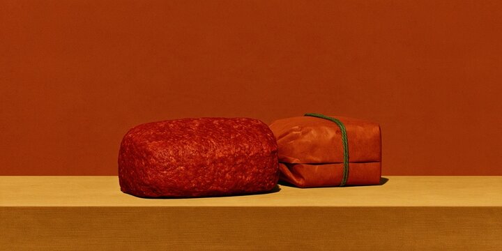 Ground beef in a kraft paper parcel with green twine, a monochromatic and minimalist setup with copy space for food safety and product recall
