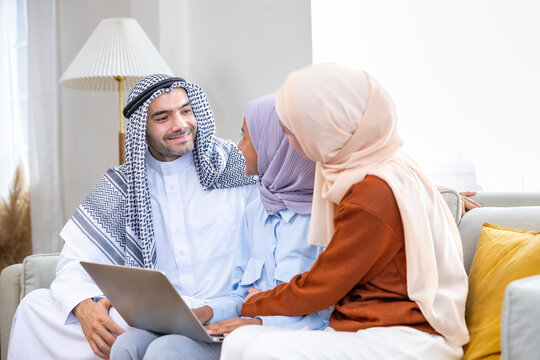 Middle east muslim parent are teaching their kid to doing homework and school assignment using laptop for online education, social media and ai tool related concept