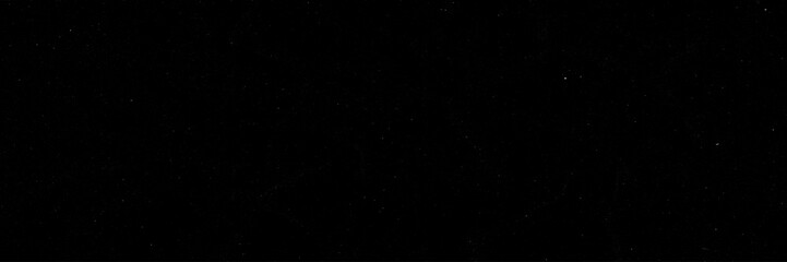 Deep Black Outer Space Background Scattered with Subtle Tiny Stars with Copy Space for Cosmic Designs. © RawAesthetic