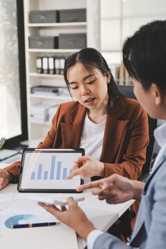 Business professional analyzing financial data on digital tablet dashboard with calculator and laptop, representing accounting software, ERP system integration, performance monitoring.