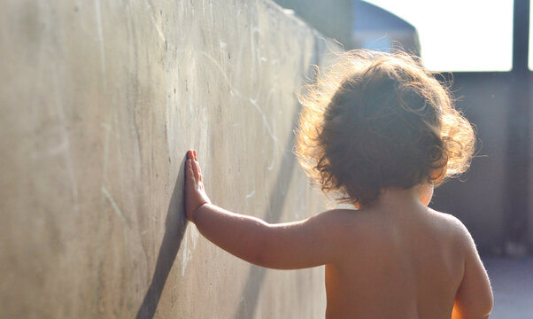 Back view of toddler with messy hair.