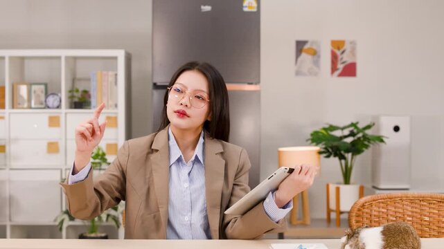 Asian Businesswoman Interacting with Virtual Screen Using Tablet at Home