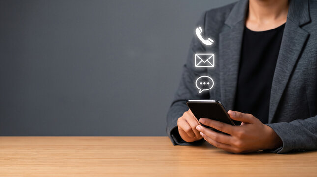 Business professional holding smartphone with floating contact icons for phone, email, and chat