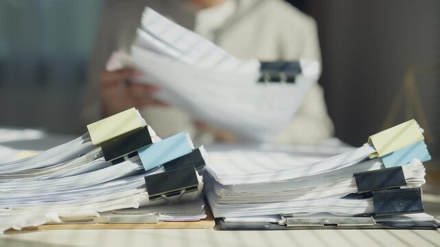 Legal professional reviewing documents at an office desk with scales of justice, representing legal consultation, case preparation, contract review, compliance, research, and professional law services